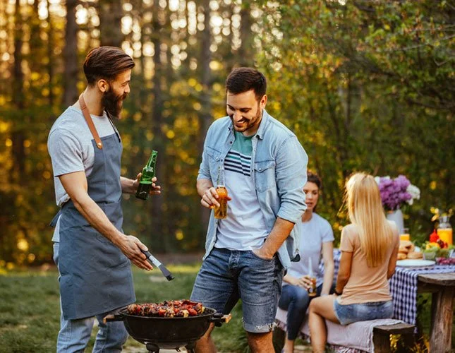 Man Drinking While Grilling