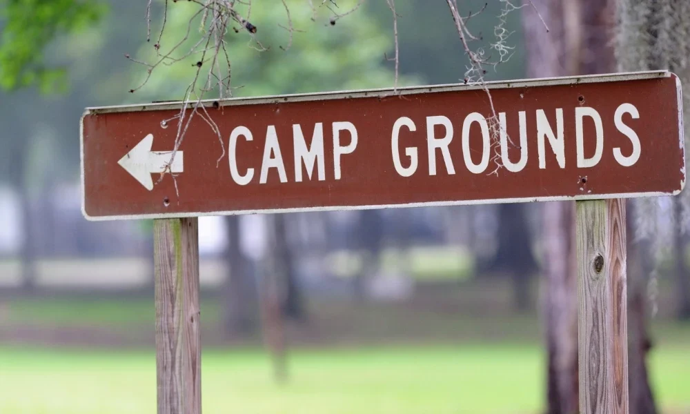 A sign pointing left and reads, "Camp Grounds"