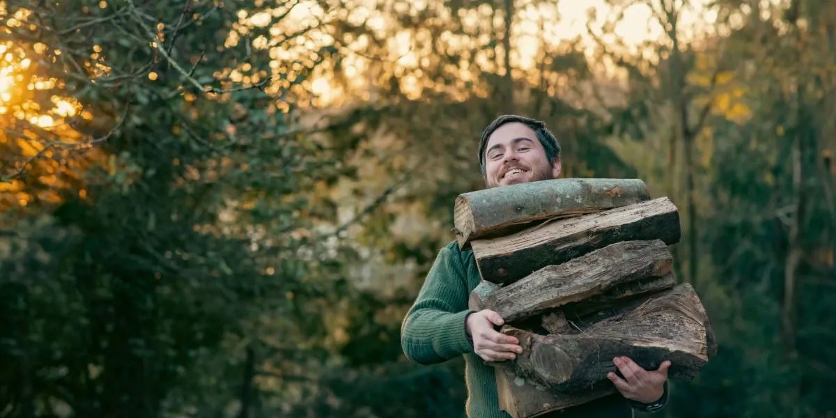 Man carrying a pile of firewood