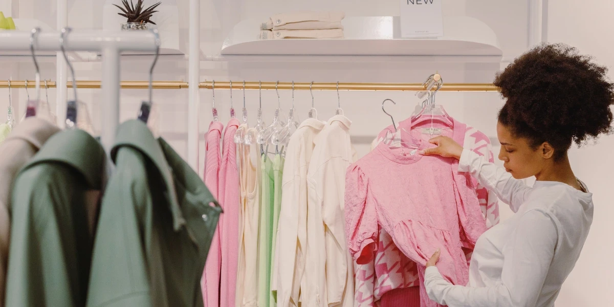 Woman browsing a clothes rack for tops