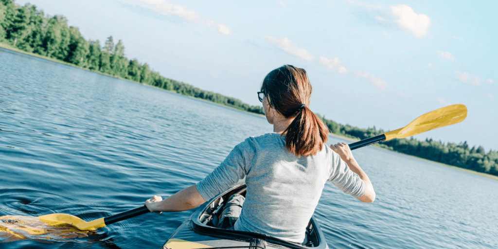 A woman on a kayak on a lake