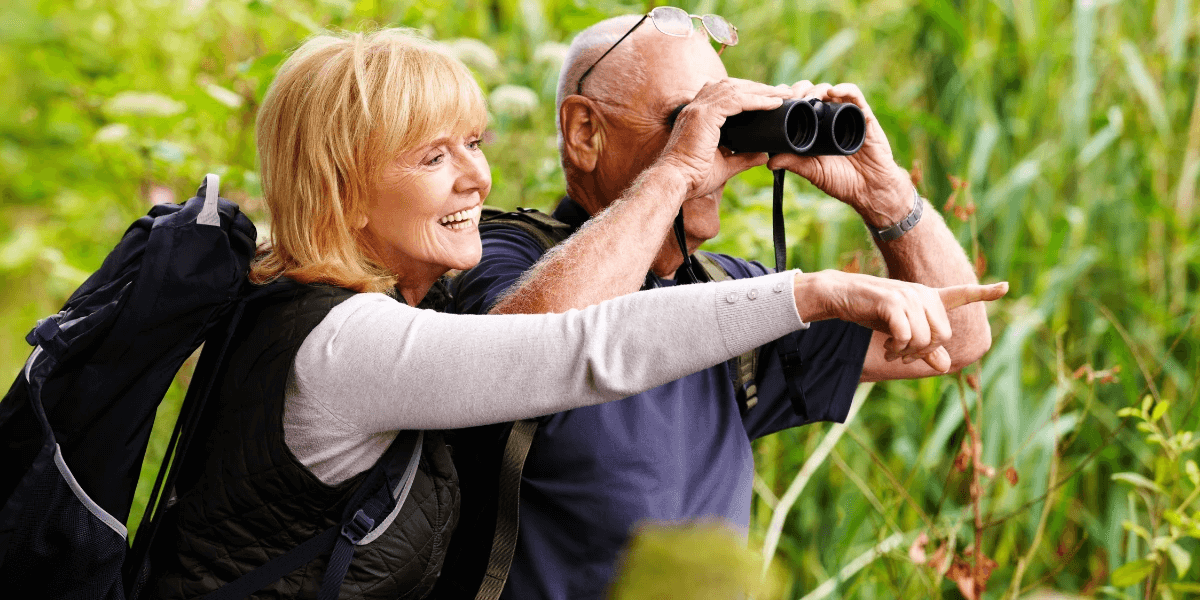 An elderly couple bird watching