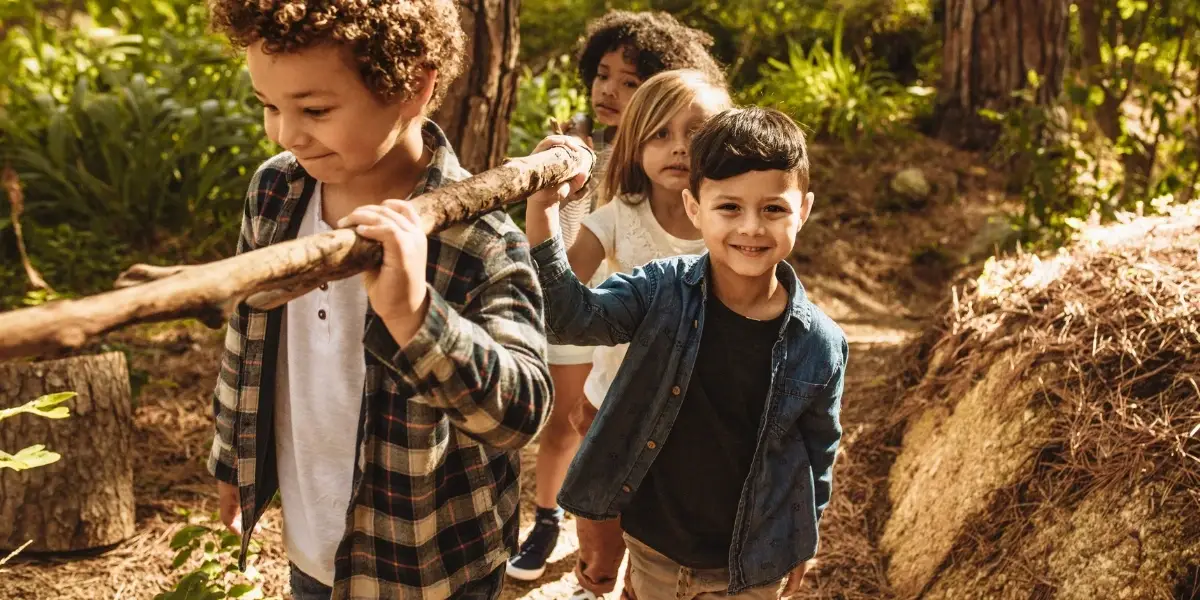 Kids playing at the edge of the forest