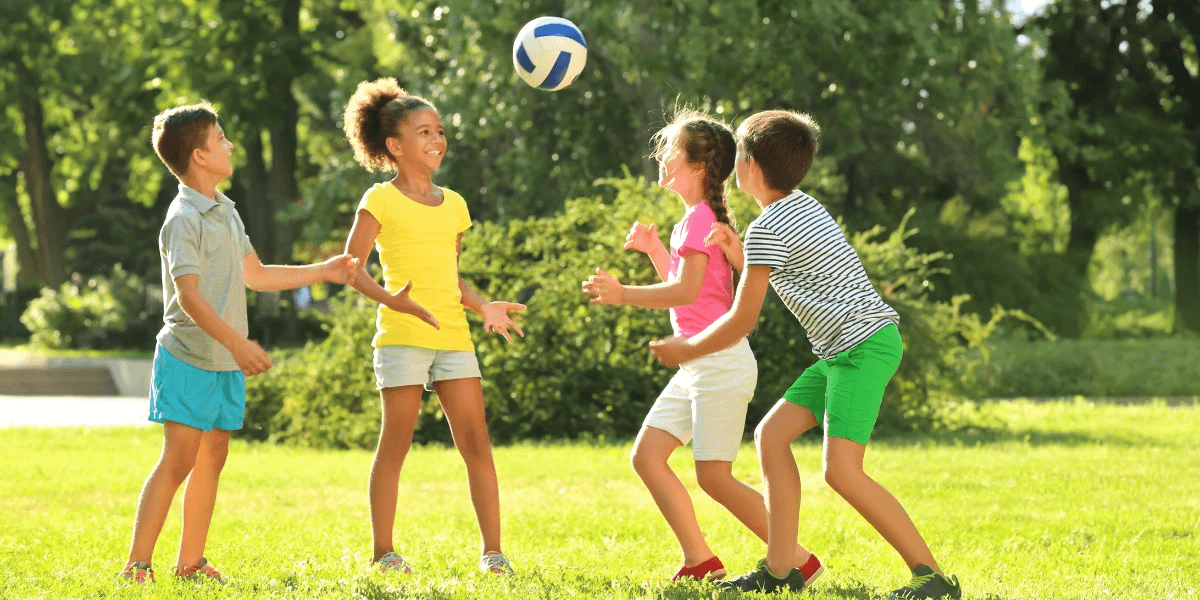 Kids playing with a ball on a sports field