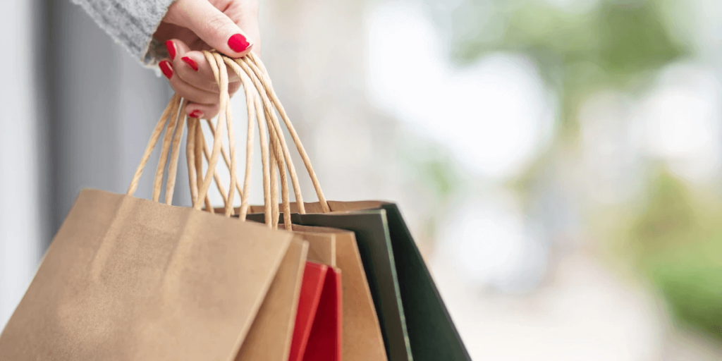 Woman's hands holding shopping bags