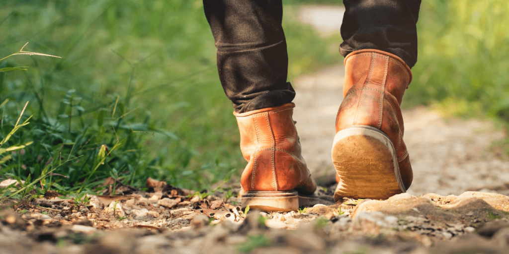 closeup of a man's feet as he goes hiking