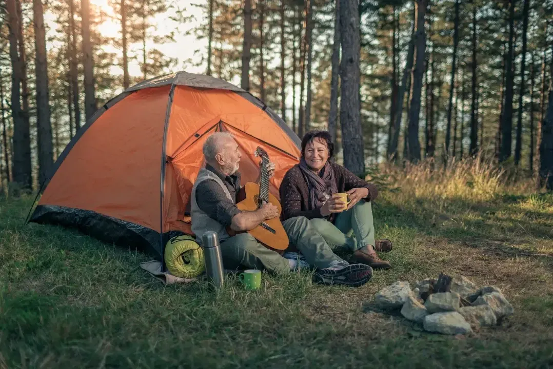 A couple camping outdoors