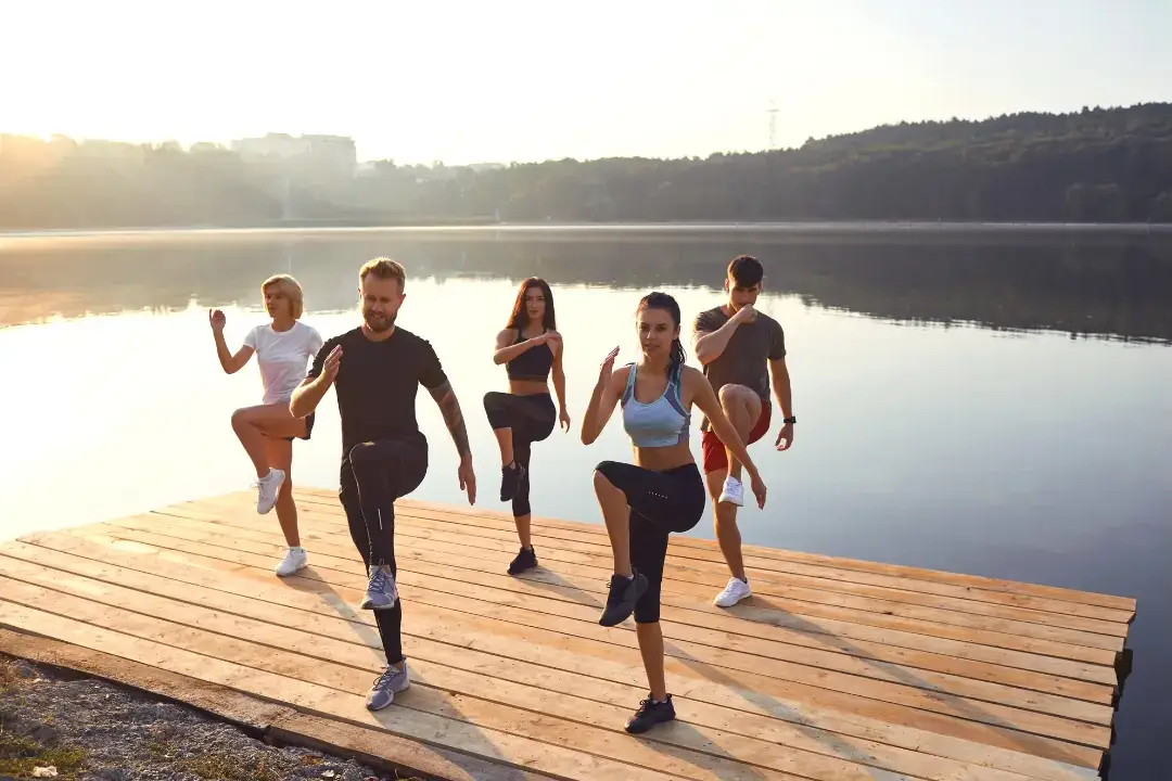 A group warming up beside the lake.